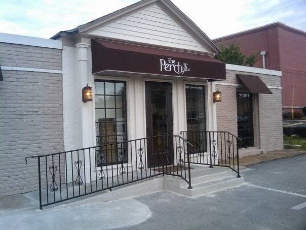 The Perch storefront on Franklin Road: a brown awning with the Perch logo, lantern lights and an iron railing